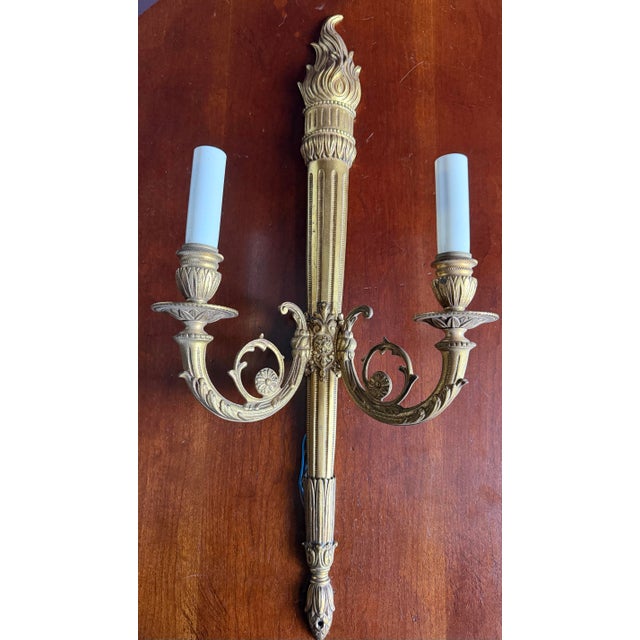 Beautiful pair of vintage neoclassic brass or Bronze Dore’ wall sconces with torch and flame motif. Wired. Great...