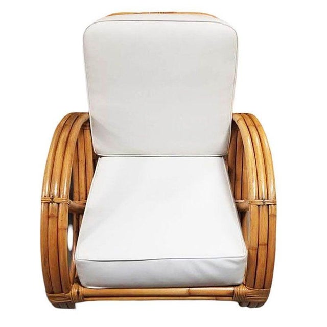 Beautifully restored rare 3-strand round full pretzel arm rattan lounge chair with fancy wicker wrappings. This design is...