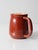 This vintage handmade studio pottery pitcher features a classic rounded shape, a wide handle, and a gently curved spout....