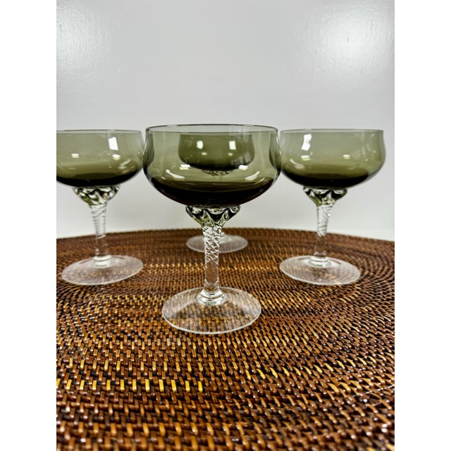 A refined set of four vintage Sasaki “Coronation Smoke” coupe glasses, crafted in Japan and celebrated for their...