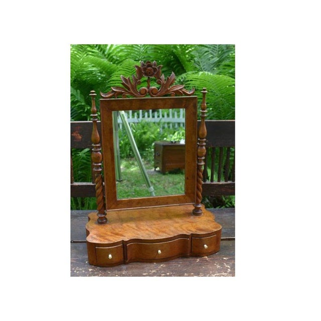 A Scandinavian dressing glass circa 1840 in wavy birch with serpentine drawer fronts and bone pulls. The fine floral...