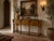 Beautiful vintage Mediterranean Spanish Colonial style console table featuring a warm wood finish. A charming and...