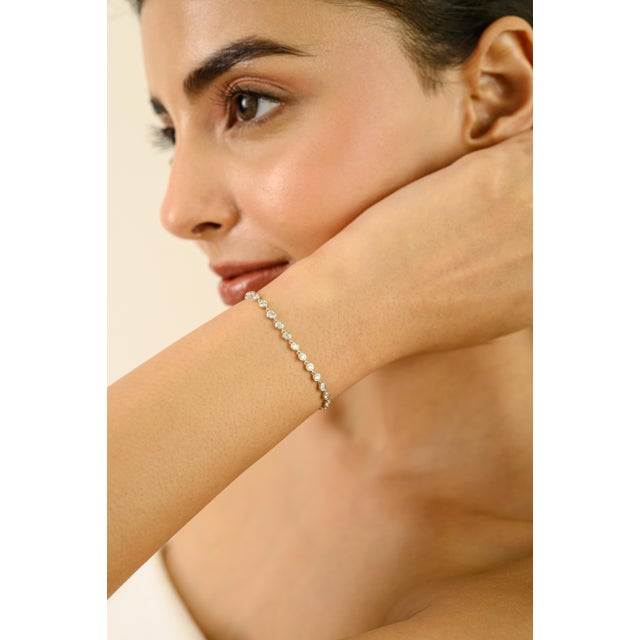 This elegant diamond tennis bracelet showcases 39 round-cut diamonds totaling 3.63 carats, beautifully set in 14K white...