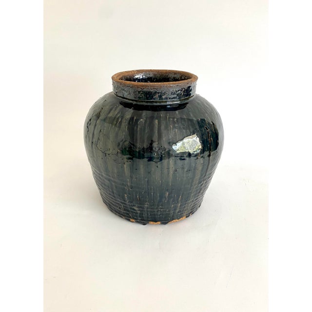 This beautiful and heavy black glazed pot was used in China for storing wine or water. No two are alike and flaws are part...