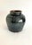 This beautiful and heavy black glazed pot was used in China for storing wine or water. No two are alike and flaws are part...