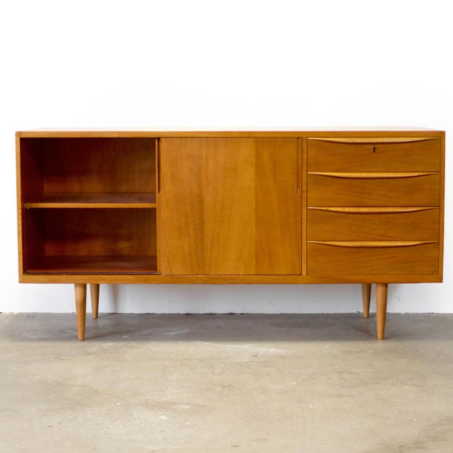 Dimensions: 59 1/8” L x 19” D x 29 7/8” H Origin: German Democratic Republic (East Germany) Designer: Franz Ehrlich...