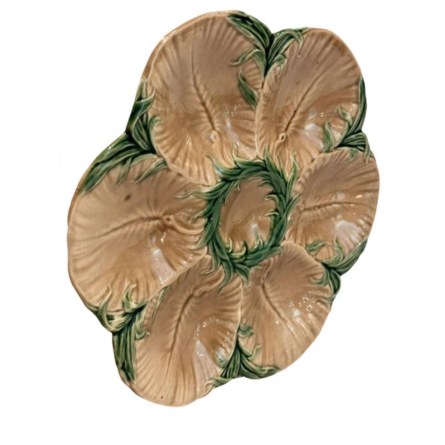 A truly rare find that you won't want to miss, this antique Luneville oyster plate with its rich green and brown palette...