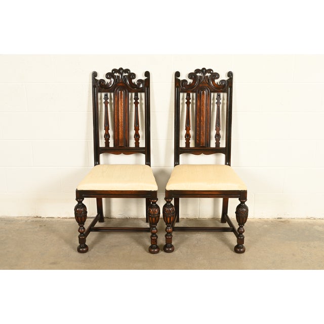 A beautiful pair of antique English Jacobean or Tudor style side chairs or dining chairs By Berkey & Gay USA, Circa 1920s...