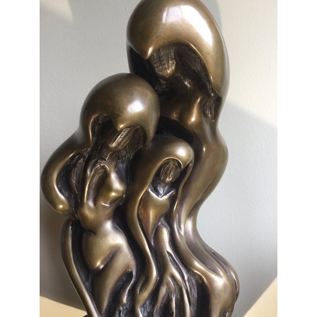 Twentieth century contemporary sculpture. The sinuous shape with a root-like base. The merging forms may suggest unity and...