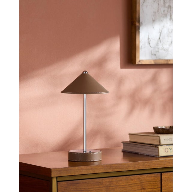 Illuminate your space with a touch of mid-century modern flair, courtesy of the Nomelle accent table lamp. Standing at an...