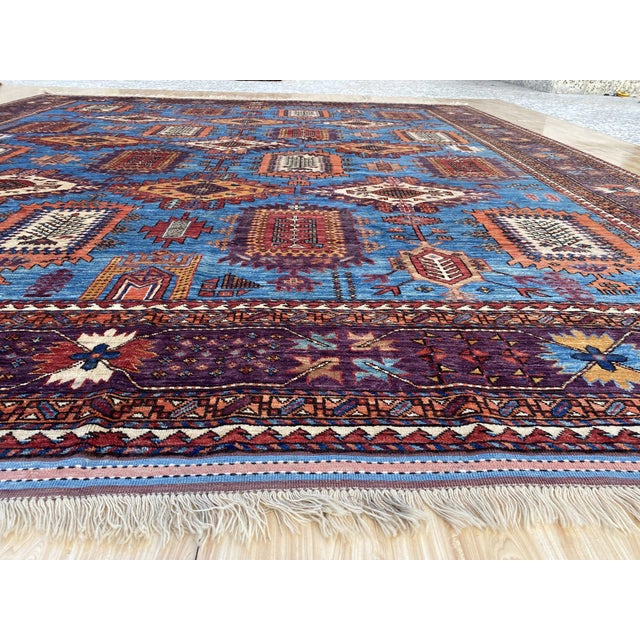This vintage rug was hand-knotted in wool, woven in Afghanistan in the Moghan Kazak Caucasian tribal design tradition....