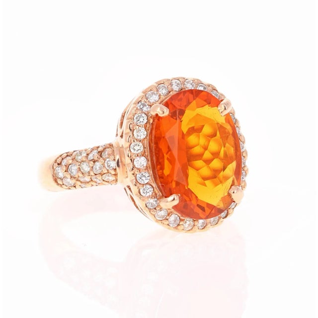 This ring has a 3.30 carat Oval Cut Fire Opal in the center of the ring and is surrounded by 66 Round Cut Diamonds that...