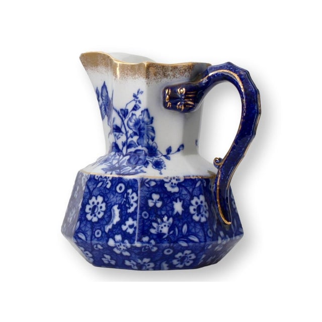 Antique English flow blue ironstone water pitcher with a striking octagonal base and rich cobalt transfer in a floral and...