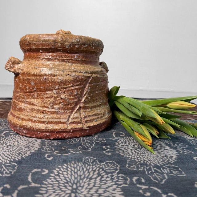 This unique Shigaraki Mizusashi is a beautiful example of traditional Japanese ceramics: originally made as a water vessel...