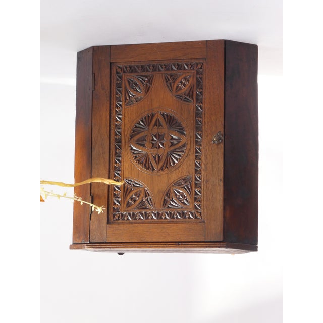 Antique Dutch chip carved wooden corner cabinet. The wall cabinet has a beautiful carved door in the front by a Dutch Folk...