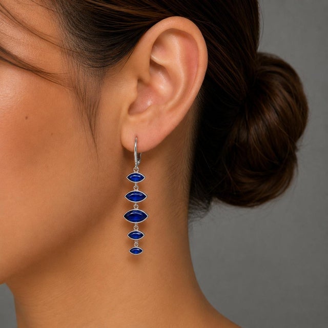 These stunning 14K White Gold Sapphire Dangle Earrings are a true statement piece, featuring 10 natural sapphires in...