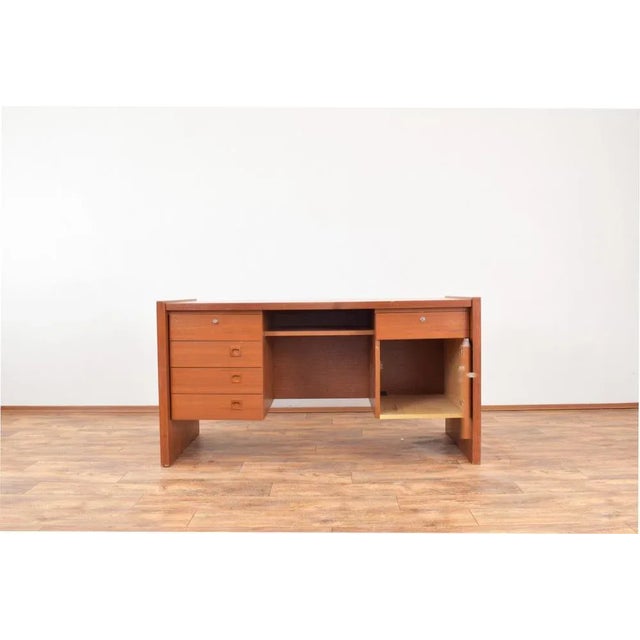 This teak desk was made in Denmark in the 1980s. The furniture is preserved in its original condition with traces of use...