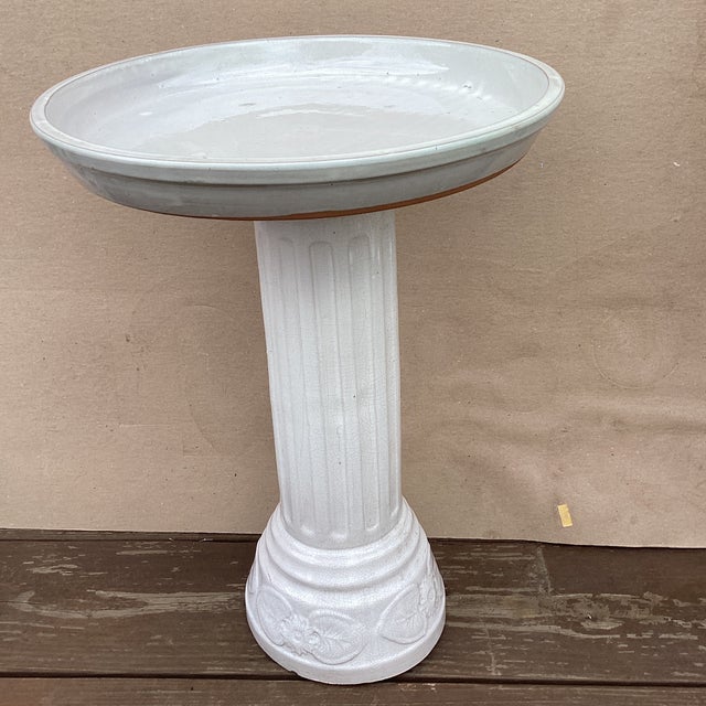 This Vintage White Ceramic Terracotta Glazed Column Pedestal Bird Bath is a stylish and functional addition to any garden...