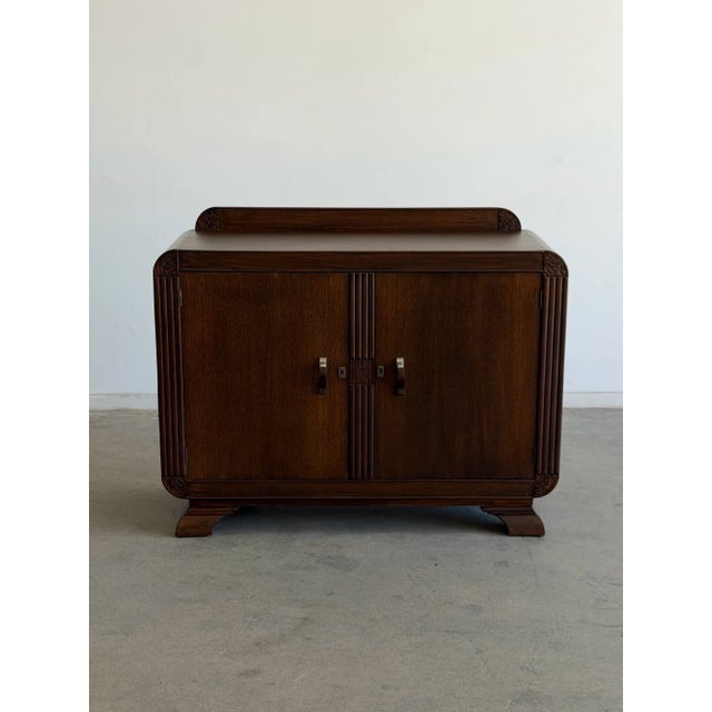 W48 D19.25 H38 A beautifully restored Art Deco cabinet featuring elegant proportions, rounded waterfall corners, and...