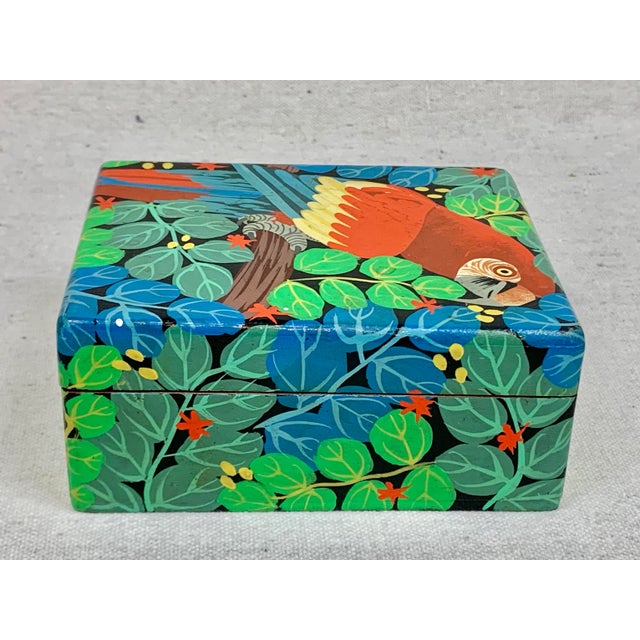 Amazing vintage hand painted box. Made of wood. Features a colorful parrot and rainforest design. Perfect to store playing...