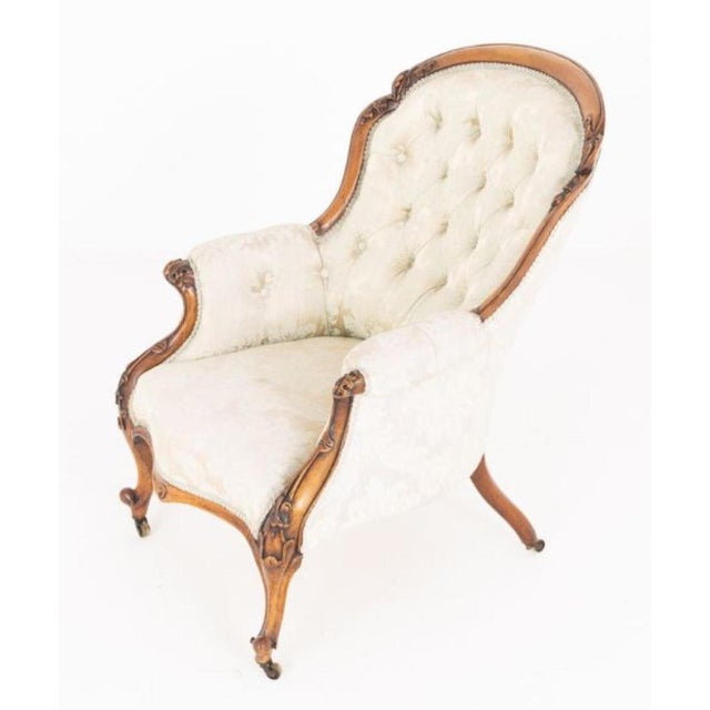 This elegant Victorian chair is crafted in rich mahogany and raised upon finely shaped cabriole legs, terminating in...