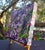 This artwork presents a close-up view of an eye partially obscured by vibrant foliage, creating an intimate connection...