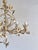 Vintage Italian floral tole chandelier with five candle-style lights, decorated with hand-shaped metal flowers, buds,...