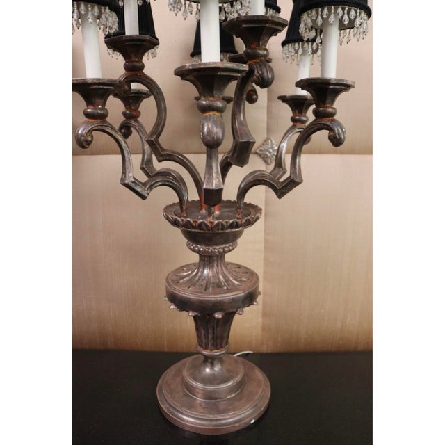 An exceptional and rare pair of vintage Italian mid-century candelabra table lamps heavily styled in the opulent Hollywood...