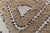 This modern half-pile rug offers a refined take on abstract design, blending sculptural patterning with a subtle, tactile...