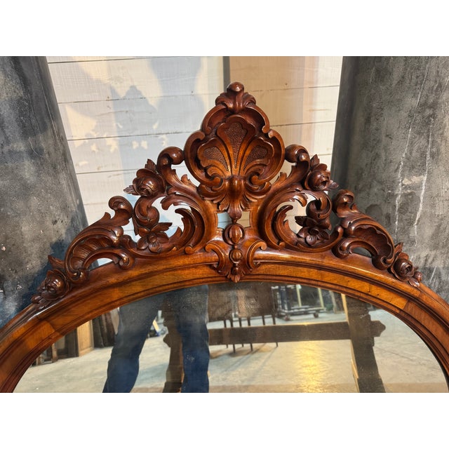 A stunning French Wall Mirror dating to the mid 19th Century. The frame is sold walnut and the carved top piece is...