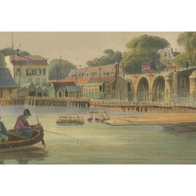This captivating hand-colored lithograph titled *De Hooge Sluis. Le Pont de l’Amstel* offers a rare and charming view of...