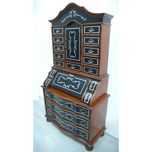Baroque-style secretary desk, walnut with black and cream accents, refinished according to antique designs. the result is...