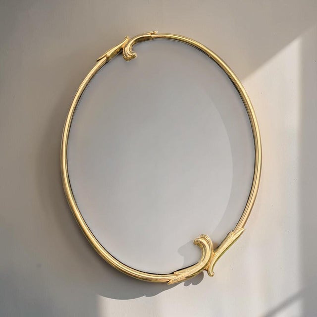 Italian design mid-century gold wall mirror. Oval shape with gold details - excellent condition. 34h 25w 1d