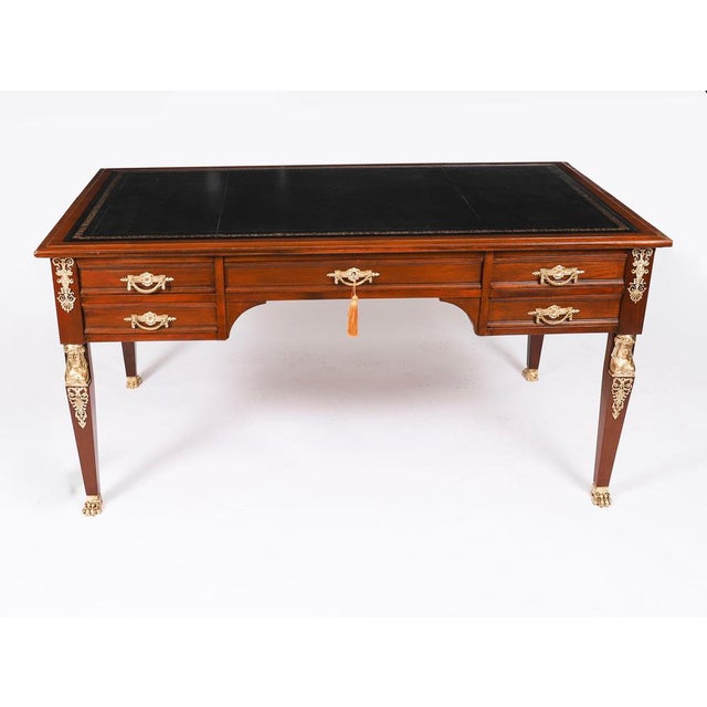 This is a fine antique French gilt-bronze mounted flame mahogany Empire bureau plat, Circa 1820 in date. The rectangular...