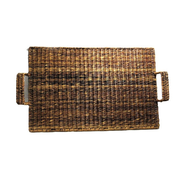 This is so cool !. Tightly woven, with handles and it is footed. 22" long and 13" wide, has the warmth of a wood element....