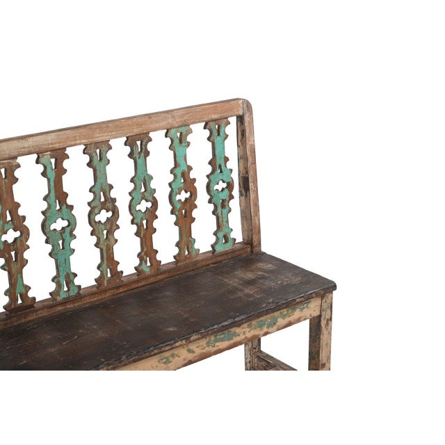 This Vintage Indian Painted Teakwood Bench has a decorative back featuring a series of intricately pierced vertical splats...