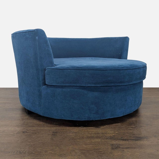 Add style and comfort to your space with this modern blue velvet round lounge chair. Its wide, circular design and soft...