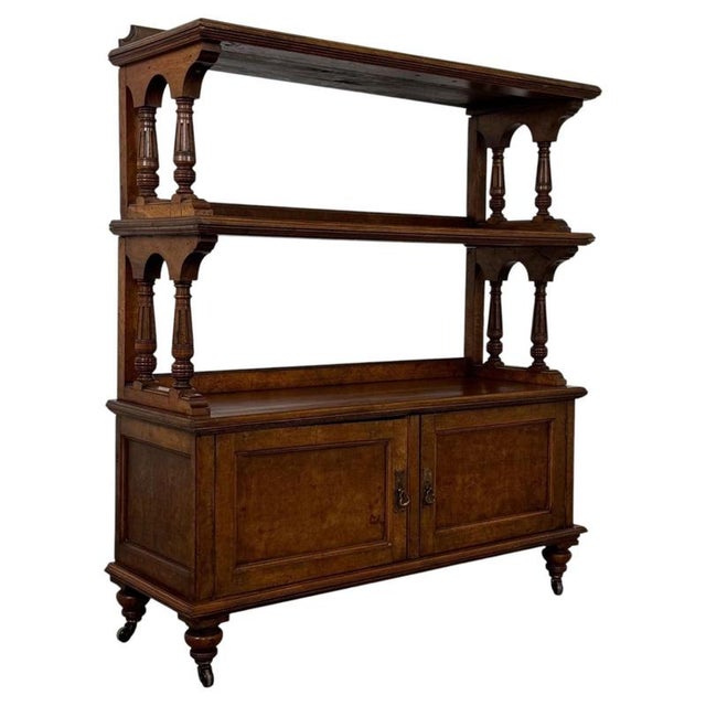 An elegant 19th-century English Victorian cupboard, finely crafted in burr walnut and distinguished by its spectacular...