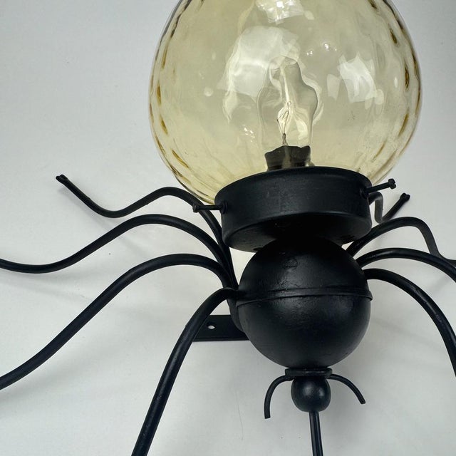 Brutalist Italian Iron and Murano Amber Glass Spider Wall Lamp, 1960s Up to 250V (Europe/UK Standard).The wiring of this...