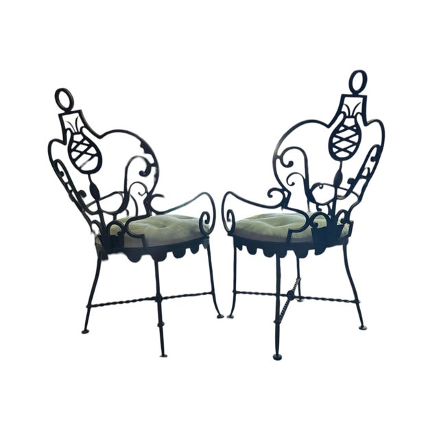 An elegant and sculptural pair of wrought-iron armchairs possibly crafted by French master wrought-iron craftsman Gilbert...