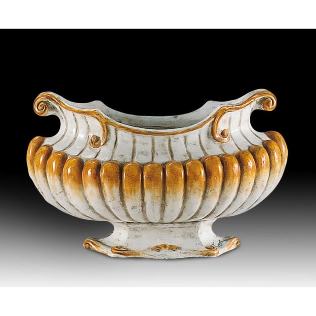 This sculptural terracotta planter is handcrafted and glazed in Italy, featuring a classic ribbed body, scrollwork rim,...