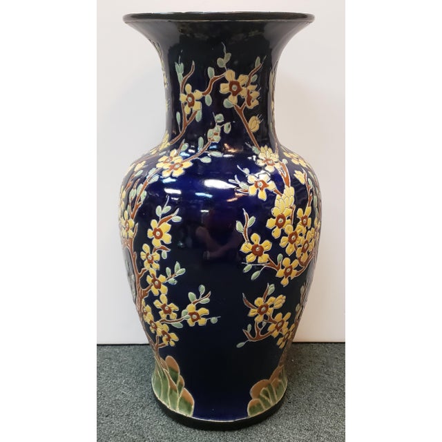 Up for sale is a Circa 1970 Chinese Fencai/Famille Rose Style on Cobalt Ground Porcelain Vase with Plum Blossoms. It...