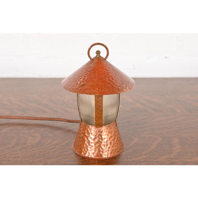 An exceptional Arts & Crafts period hand hammered copper lantern form table lamp or desk lamp In the manner of Roycroft...