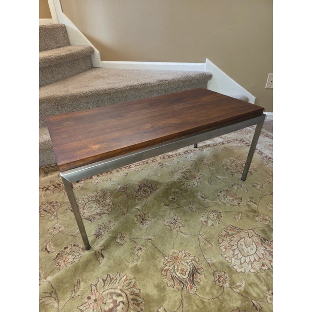 Teak and steel coffee table in the style or Mikael Laursen circa 1960. Solid block teak table with wide flat bar brushed...