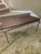 Teak and steel coffee table in the style or Mikael Laursen circa 1960. Solid block teak table with wide flat bar brushed...