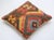 A one-of-a-kind handwoven Afghan wool kilim accent pillow featuring bold concentric diamonds in red, green, and gold. Cut...