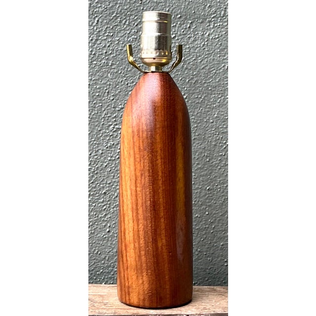 This vintage Danish Modern table lamp is a masterclass in organic minimalism, featuring an iconic bullet-shaped...