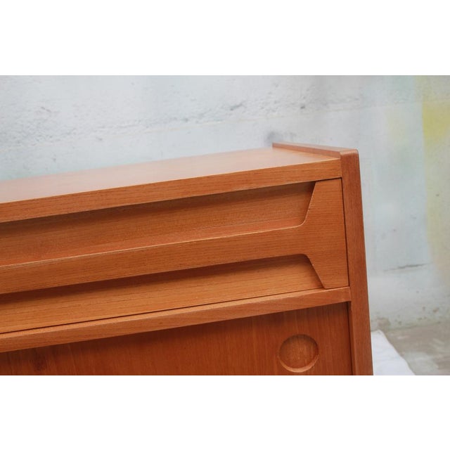 Beautiful 1950s sideboard, veneered in cherry wood. Symmetrical design, 2 drawers and 2 sliding doors. Good condition with...