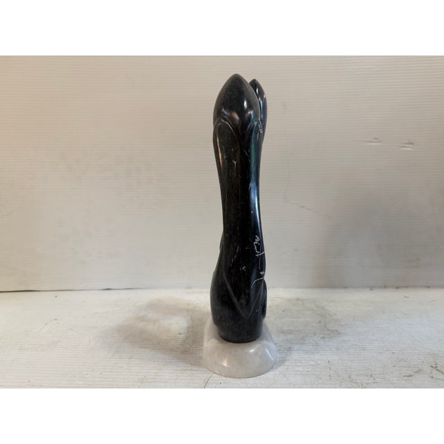 This abstract sculpture is constructed of black and white marble, with a white marble base. It's fluid form and minimalist...