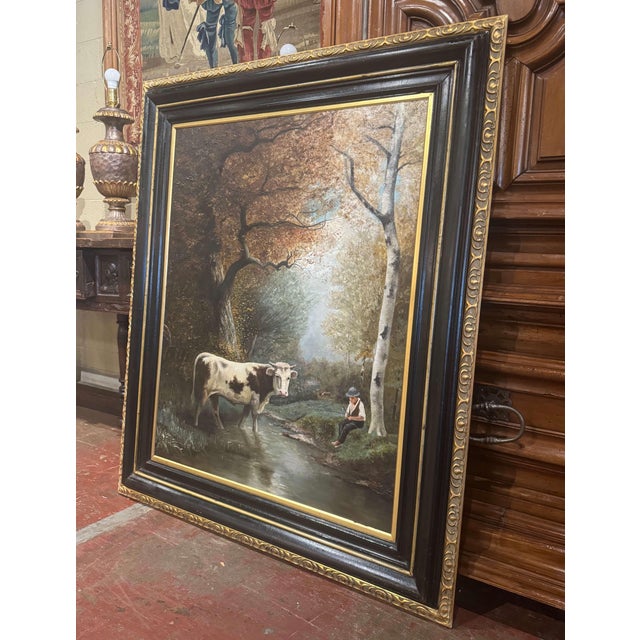 Capturing the peaceful atmosphere of the French countryside, this large antique oil painting portrays a charming pastoral...